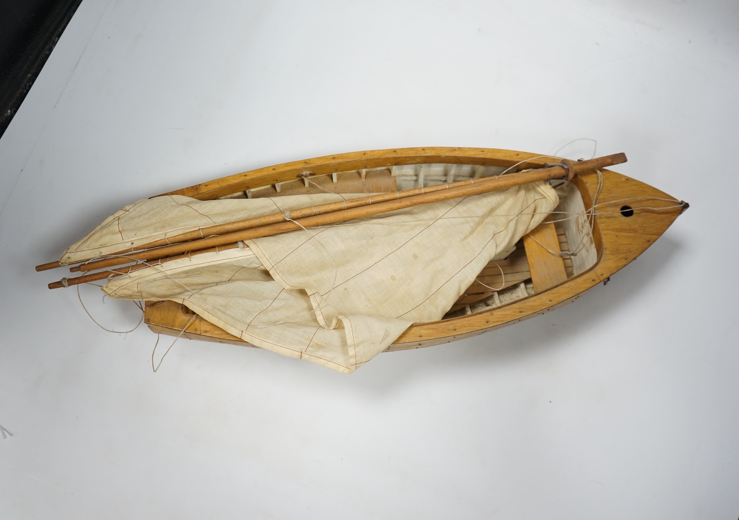 A mid 20th century kit built wooden model sailing boat, ‘Rob’, of plank on frame construction with white painted interior, hull 45cm long. Condition - fair to good.